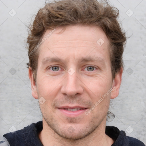 Joyful white adult male with short  brown hair and grey eyes