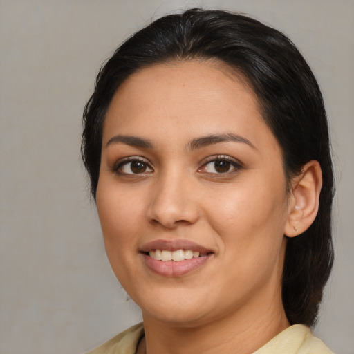 Joyful latino young-adult female with medium  brown hair and brown eyes