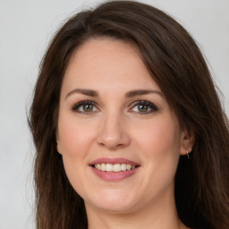 Joyful white young-adult female with long  brown hair and green eyes