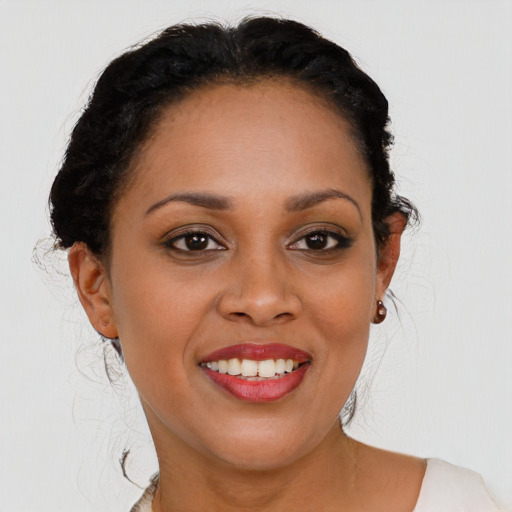 Joyful black young-adult female with medium  brown hair and brown eyes