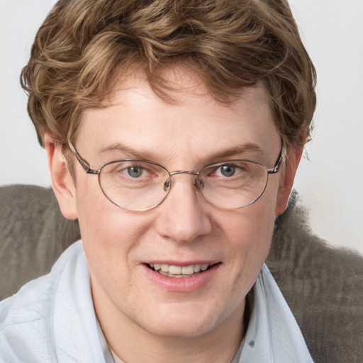 Joyful white adult male with short  brown hair and blue eyes