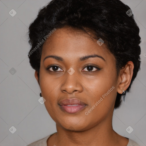 Joyful black young-adult female with short  black hair and brown eyes