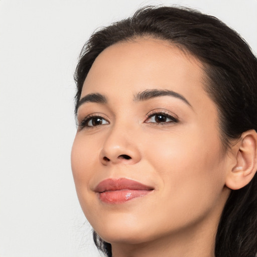 Joyful latino young-adult female with long  black hair and brown eyes