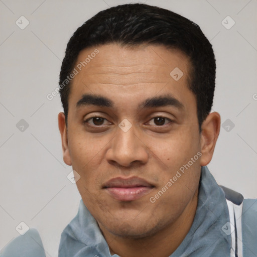 Joyful latino young-adult male with short  black hair and brown eyes