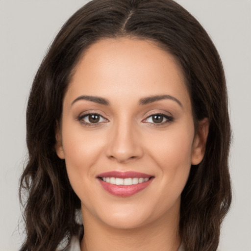 Joyful white young-adult female with long  brown hair and brown eyes