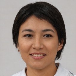 Joyful asian young-adult female with medium  brown hair and brown eyes