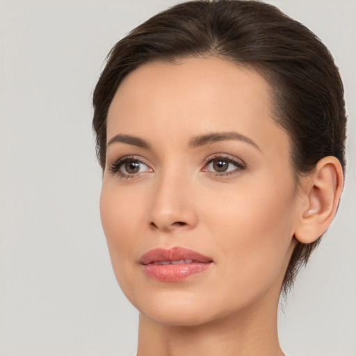 Joyful white young-adult female with medium  brown hair and brown eyes