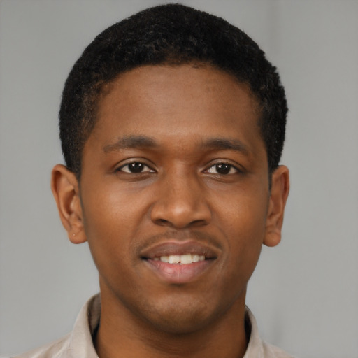 Joyful black young-adult male with short  brown hair and brown eyes