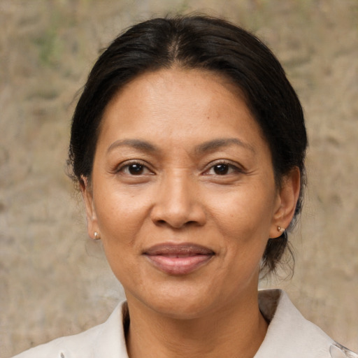 Joyful asian adult female with medium  brown hair and brown eyes