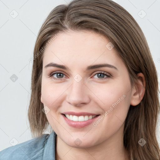 Joyful white young-adult female with long  brown hair and blue eyes