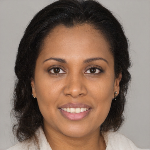 Joyful latino young-adult female with medium  brown hair and brown eyes