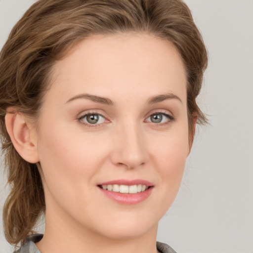 Joyful white young-adult female with medium  brown hair and blue eyes