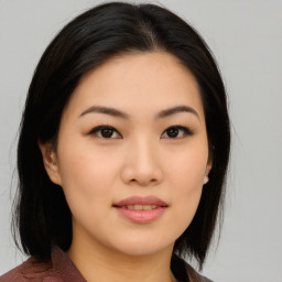 Joyful asian young-adult female with medium  black hair and brown eyes