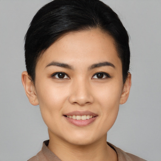 Joyful asian young-adult female with short  black hair and brown eyes