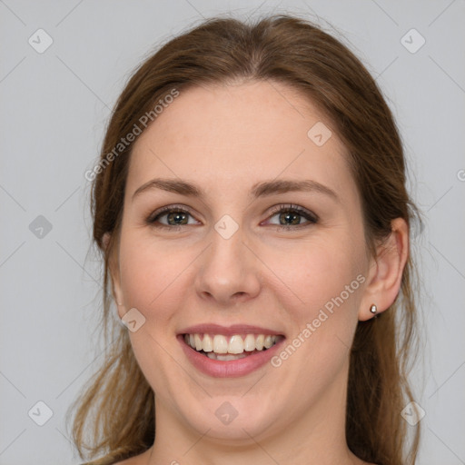 Joyful white young-adult female with long  brown hair and grey eyes