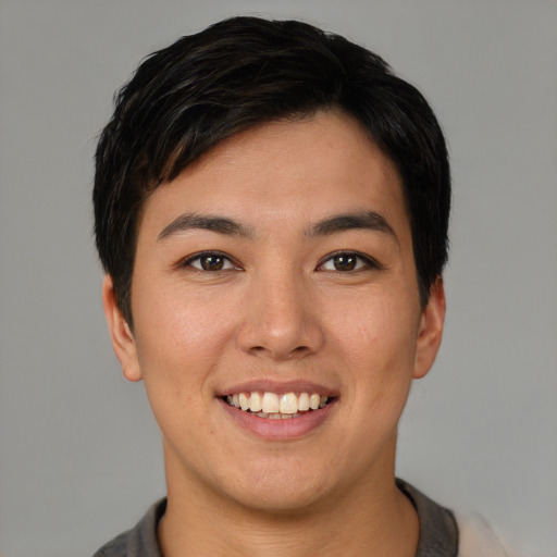Joyful asian young-adult female with short  black hair and brown eyes