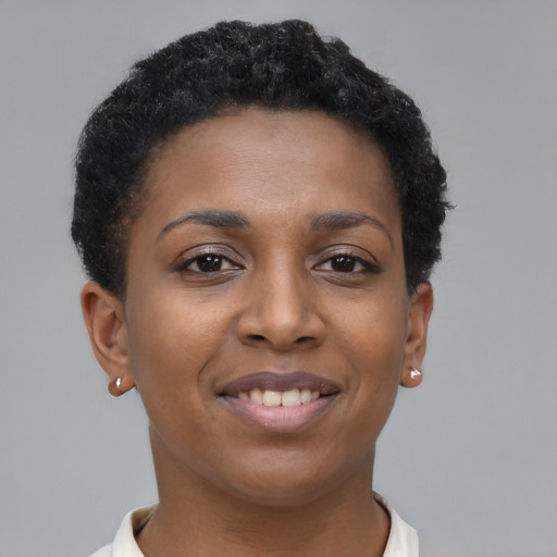 Joyful black young-adult female with short  brown hair and brown eyes