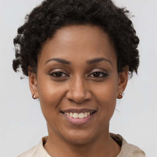 Joyful black young-adult female with short  brown hair and brown eyes