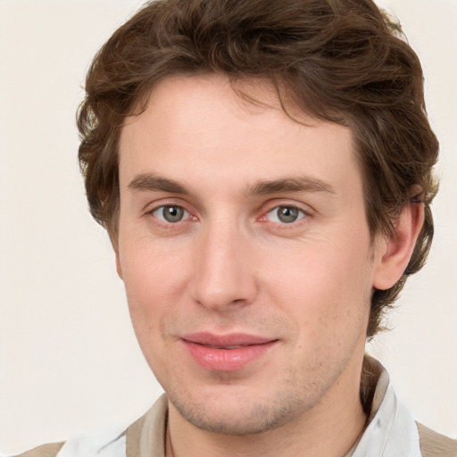 Joyful white young-adult male with short  brown hair and blue eyes