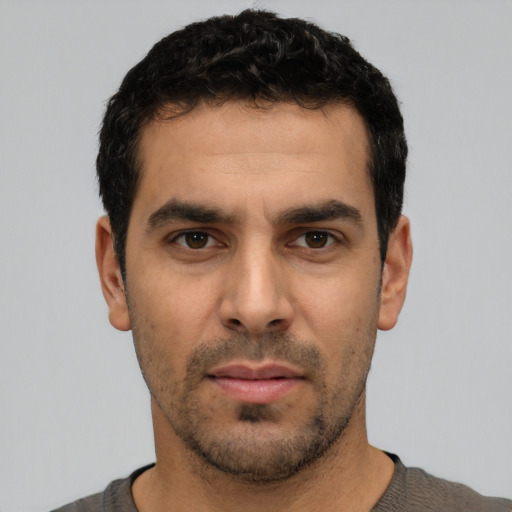 Neutral white young-adult male with short  black hair and brown eyes