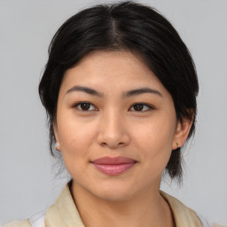 Joyful asian young-adult female with medium  brown hair and brown eyes