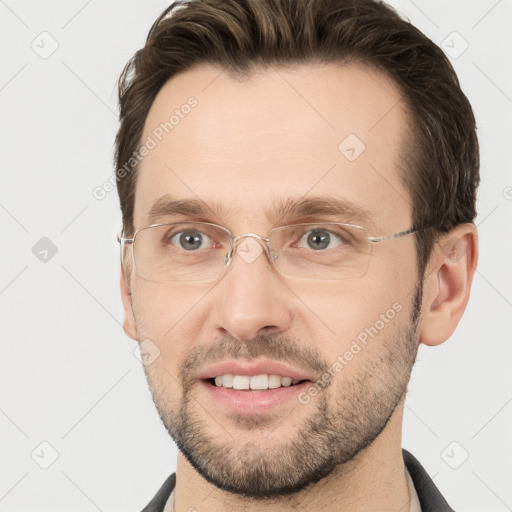 Joyful white adult male with short  brown hair and grey eyes