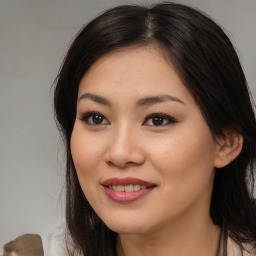 Joyful asian young-adult female with long  brown hair and brown eyes