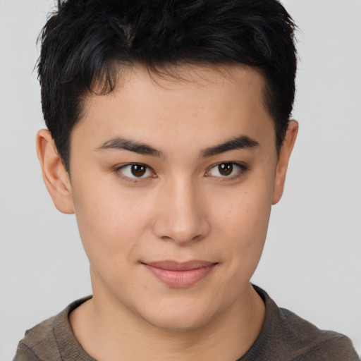 Joyful asian young-adult male with short  brown hair and brown eyes