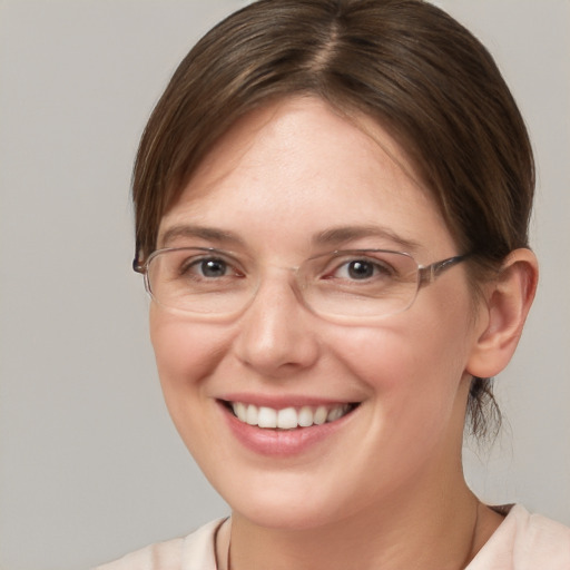 Joyful white young-adult female with medium  brown hair and grey eyes