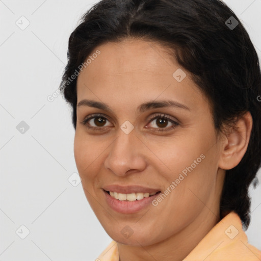 Joyful latino young-adult female with medium  brown hair and brown eyes