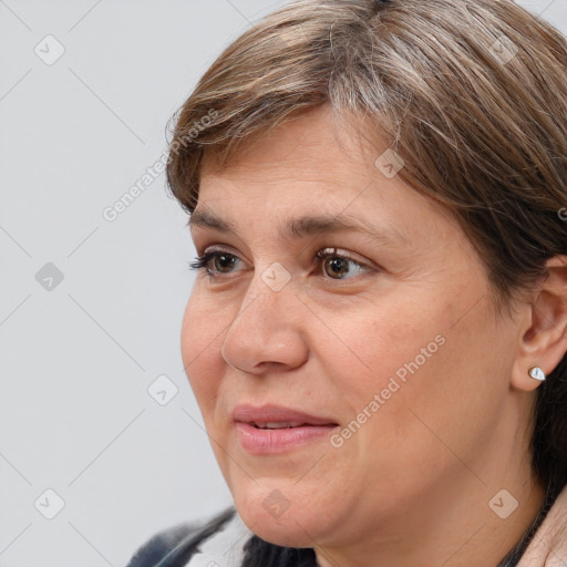 Joyful white adult female with medium  brown hair and brown eyes