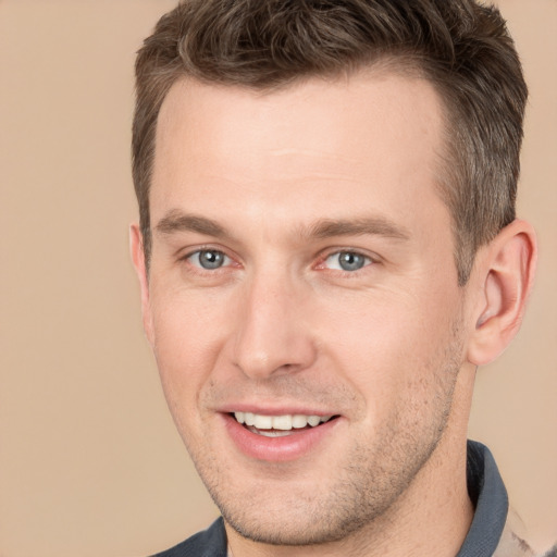 Joyful white young-adult male with short  brown hair and brown eyes