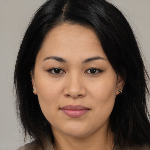 Joyful asian young-adult female with long  brown hair and brown eyes