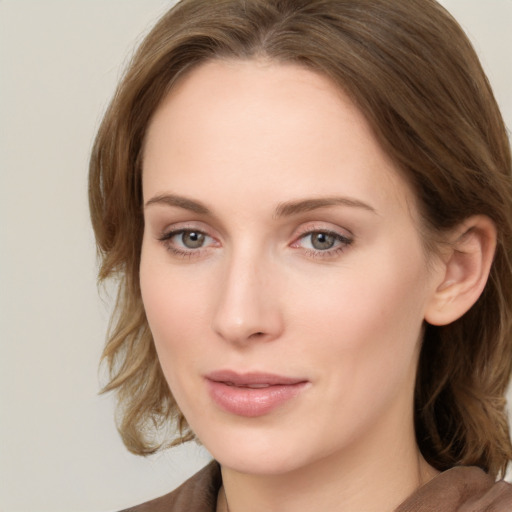 Joyful white young-adult female with medium  brown hair and blue eyes