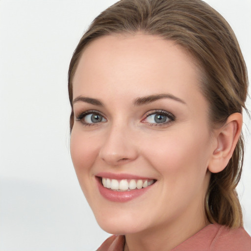 Joyful white young-adult female with long  brown hair and blue eyes