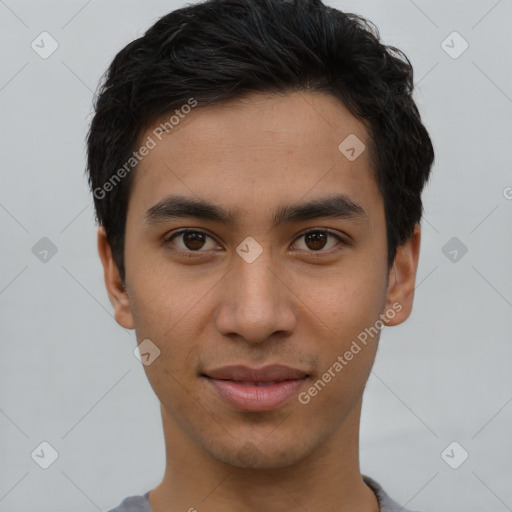 Joyful latino young-adult male with short  brown hair and brown eyes