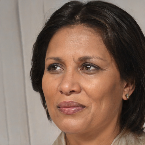 Joyful black adult female with medium  brown hair and brown eyes