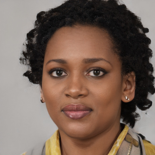 Joyful black young-adult female with medium  black hair and brown eyes
