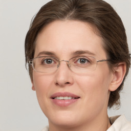 Joyful white adult female with medium  brown hair and green eyes