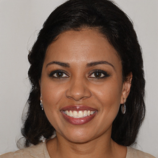 Joyful latino young-adult female with medium  brown hair and brown eyes