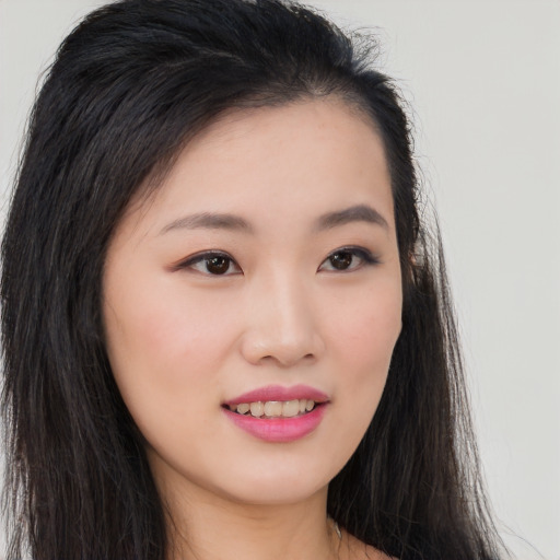 Joyful asian young-adult female with long  brown hair and brown eyes