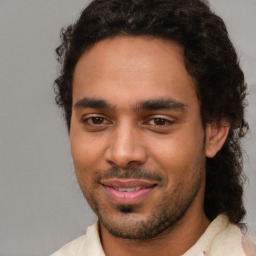 Joyful black young-adult male with short  brown hair and brown eyes