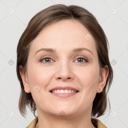 Joyful white young-adult female with medium  brown hair and grey eyes