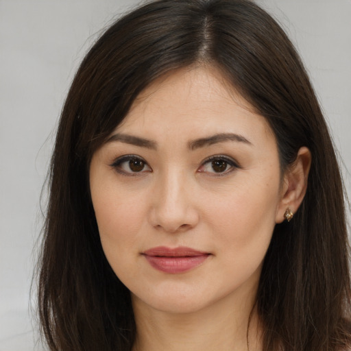 Joyful asian young-adult female with long  brown hair and brown eyes