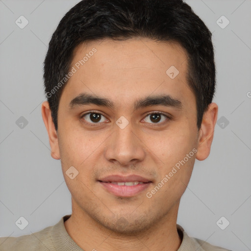 Joyful latino young-adult male with short  brown hair and brown eyes