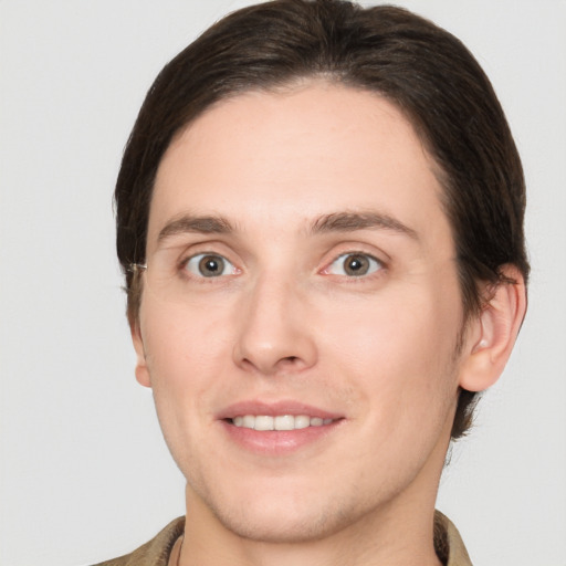 Joyful white young-adult male with medium  brown hair and brown eyes