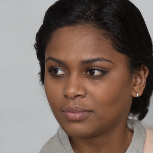Neutral black young-adult female with medium  brown hair and brown eyes