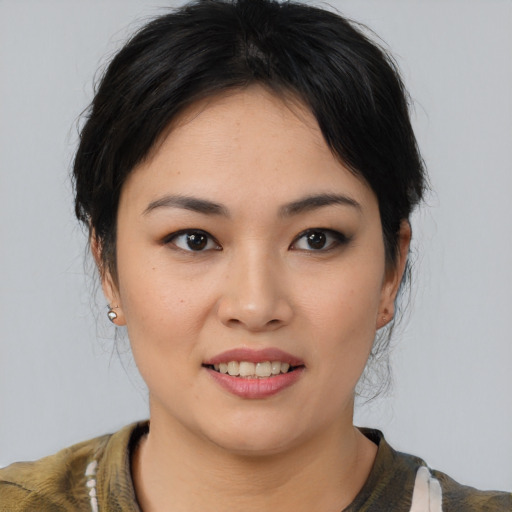 Joyful asian young-adult female with medium  black hair and brown eyes