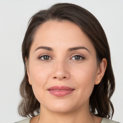 Joyful white young-adult female with medium  brown hair and brown eyes