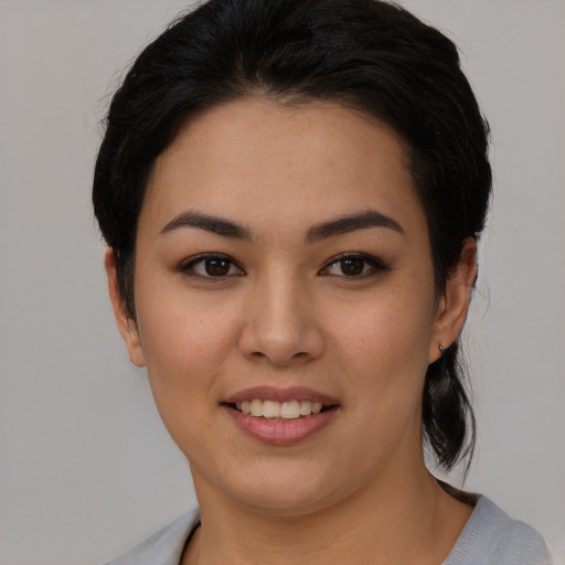 Joyful asian young-adult female with short  black hair and brown eyes